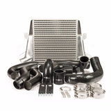 An intercooler kit with a silver stepped core, including aluminium piping, silicone joiners, and stainless steel hose clamps, primarily in black.